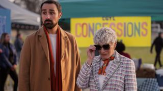 Nigel and Ginny in front of confession tent in Back in Action