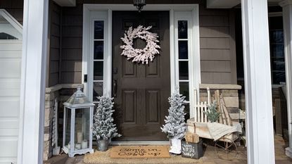 Christmas porch decor with neutral white color scheme snowy Christmas trees and white wreath