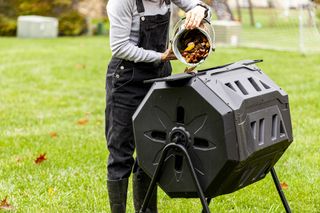 rotating compost bin with lady filling it