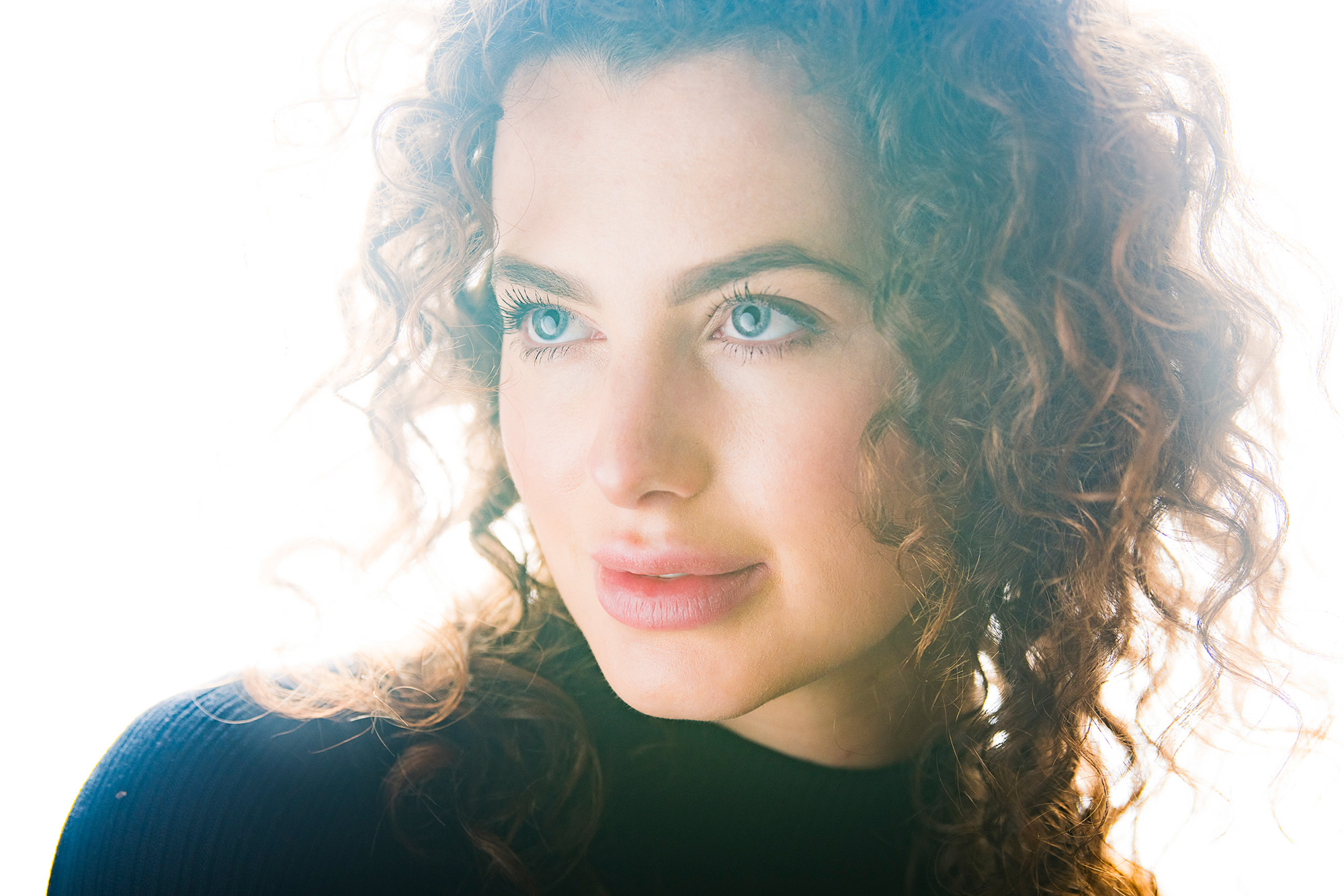 Close-up studio portrait of model against a white background by James Paterson