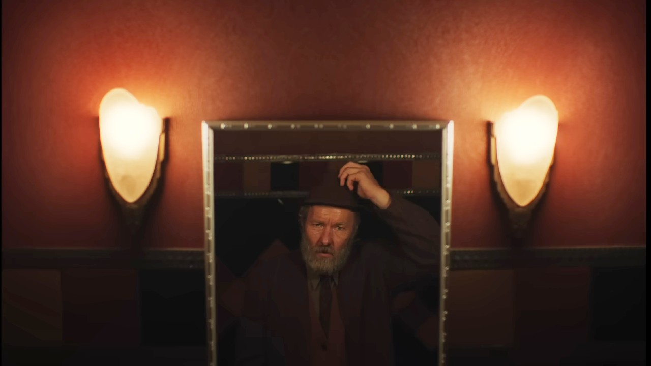 Joel Edgerton looking in the mirror in Train Dreams.