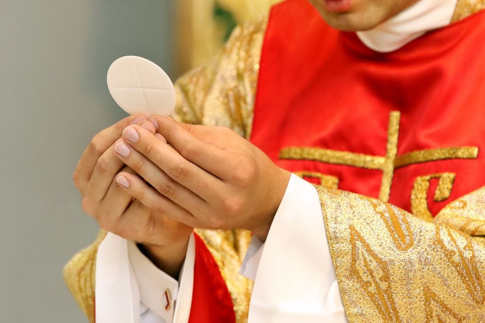 Priest celebrates mass.