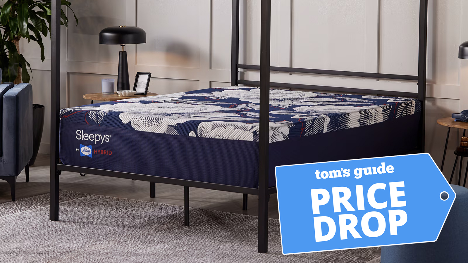 The Sleepy's By Sealy HD Firm Mattress on a bed frame in a bedroom, a Tom's Guide price drop deals graphic in the bottom right corner