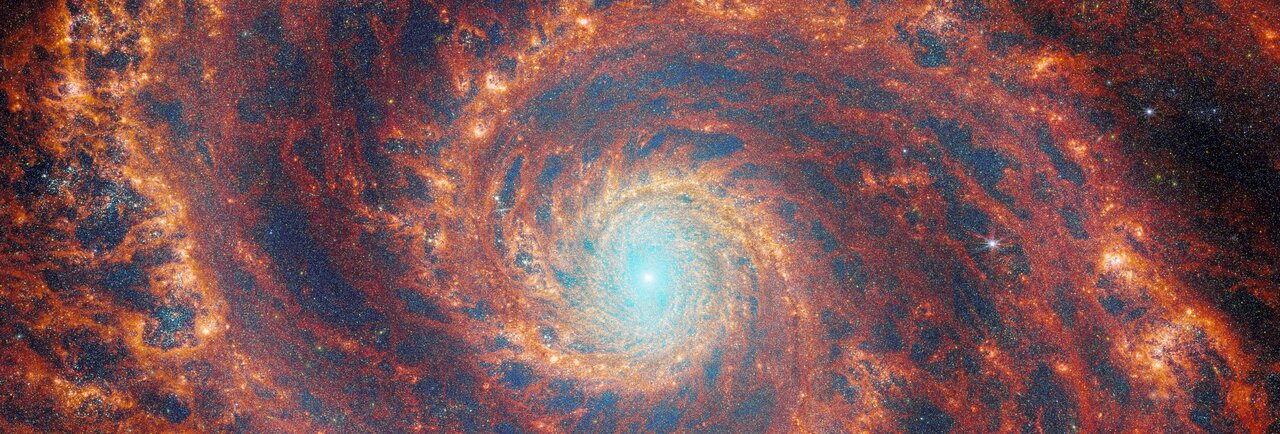 The graceful winding arms of the grand-design spiral galaxy M51 stretch across this image