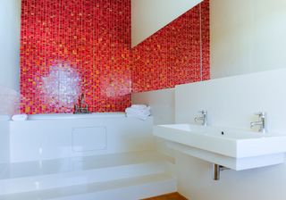 bathroom with glass mosaic tile and bathtub
