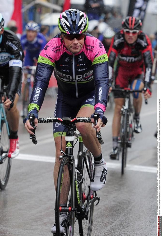 Chris Horner (Lampre-Merida) bundled up against the elements at the finish line in Girona