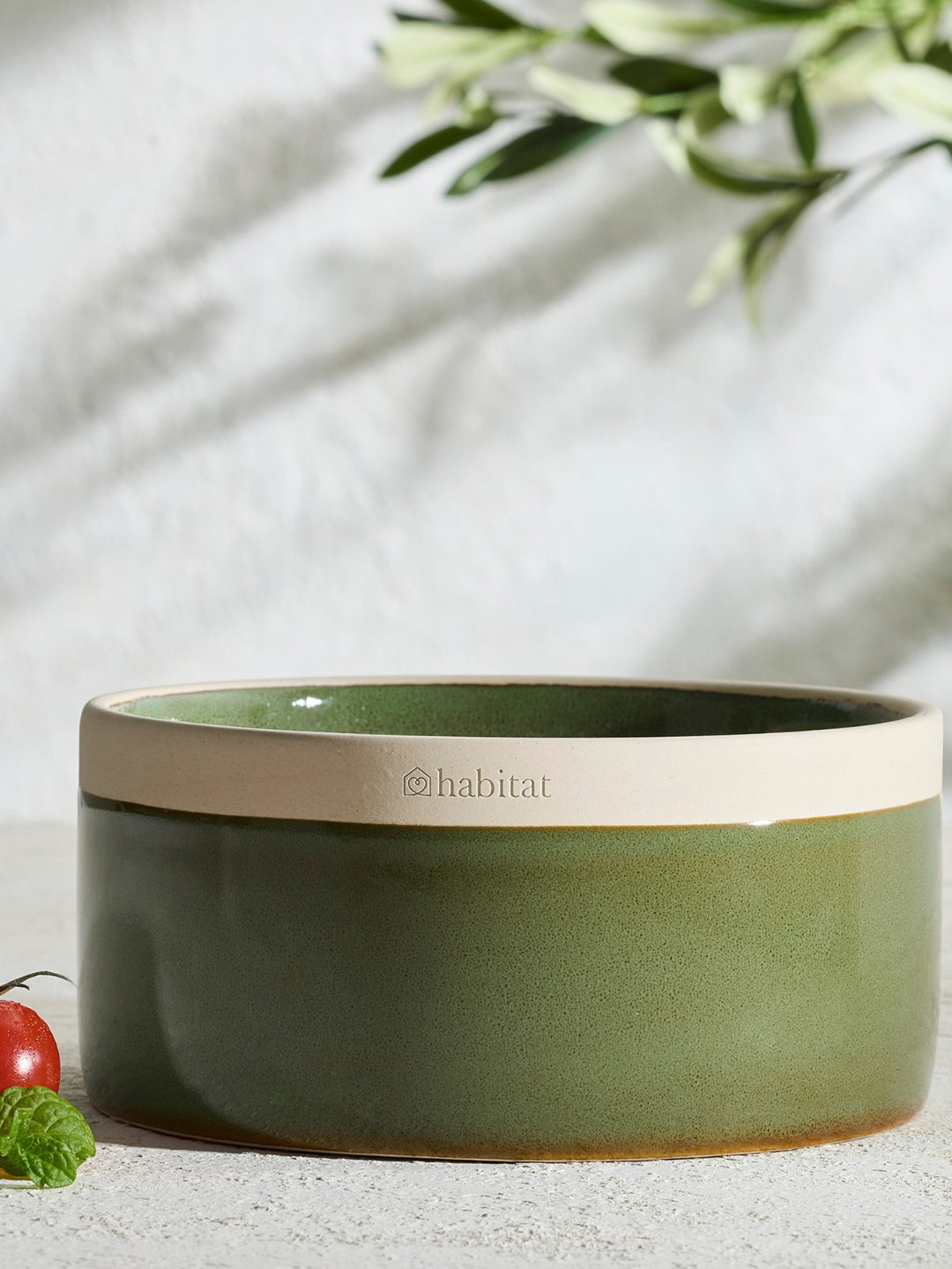 A green ceramic multi-wick candle with a tomato leaf scent from Habitat