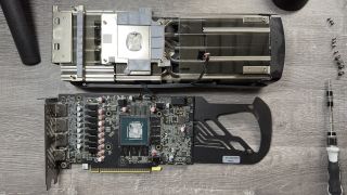 Photo of a stripped down graphics card, showing the original thermal pads