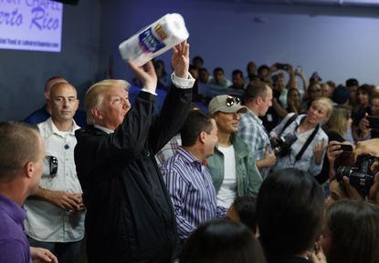 President Trump tosses paper towels into a crowd of Puerto Ricans affected by Hurricane Maria. 