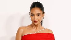 Shay Mitchell in red dress against white background