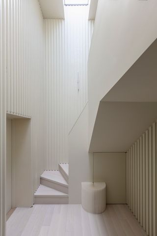 A staircase leads up to the first floor living space