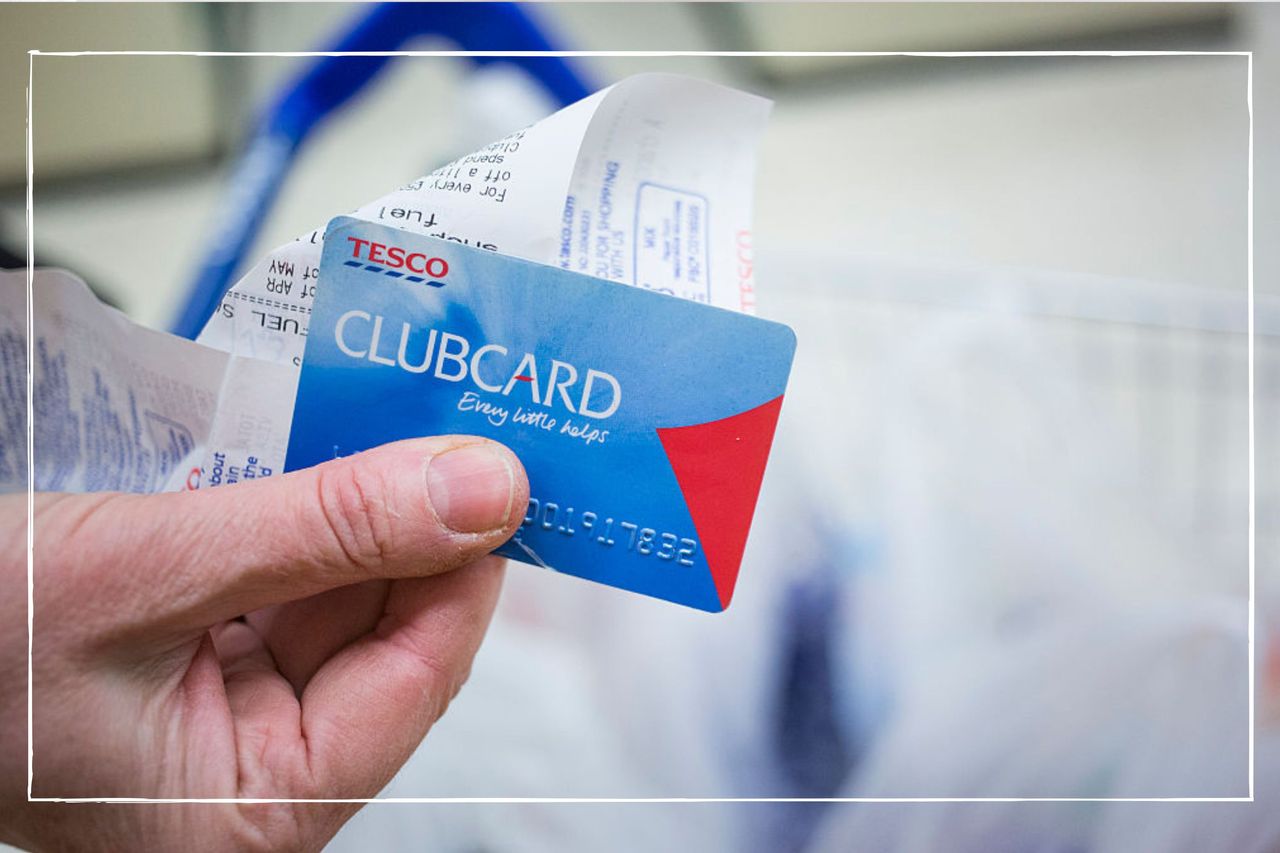 Person holding a Tesco Clubcard and receipt