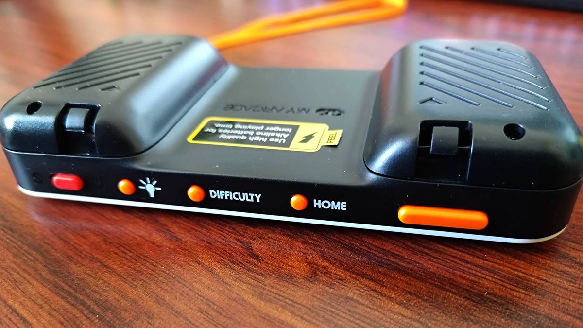 Top view of Atari Pocket Player Pro handheld power, brightness, difficulty, and home buttons next to volume toggle.