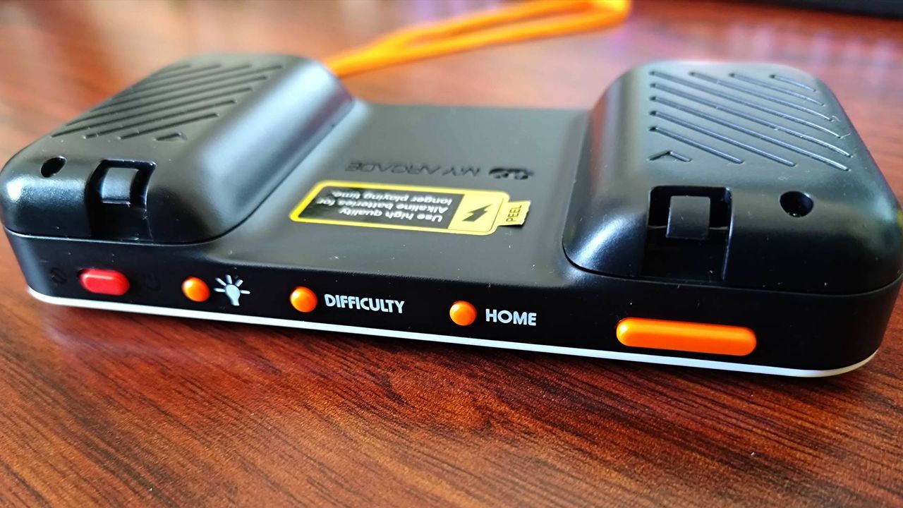 Top view of Atari Pocket Player Pro handheld power, brightness, difficulty, and home buttons next to volume toggle.