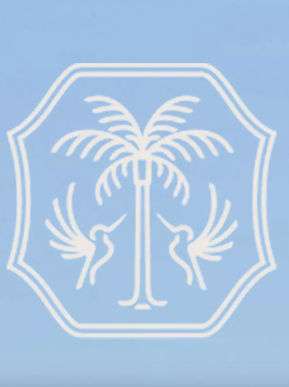 A blue logo with a white palm tree in the center flocked by two hummingbirds