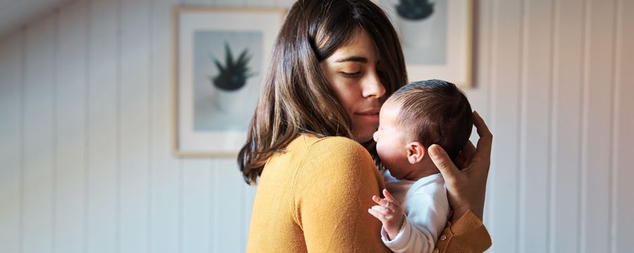 Woman holding baby at home