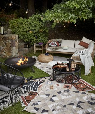 An outdoor firepit gathering with cozy outdoor rugs