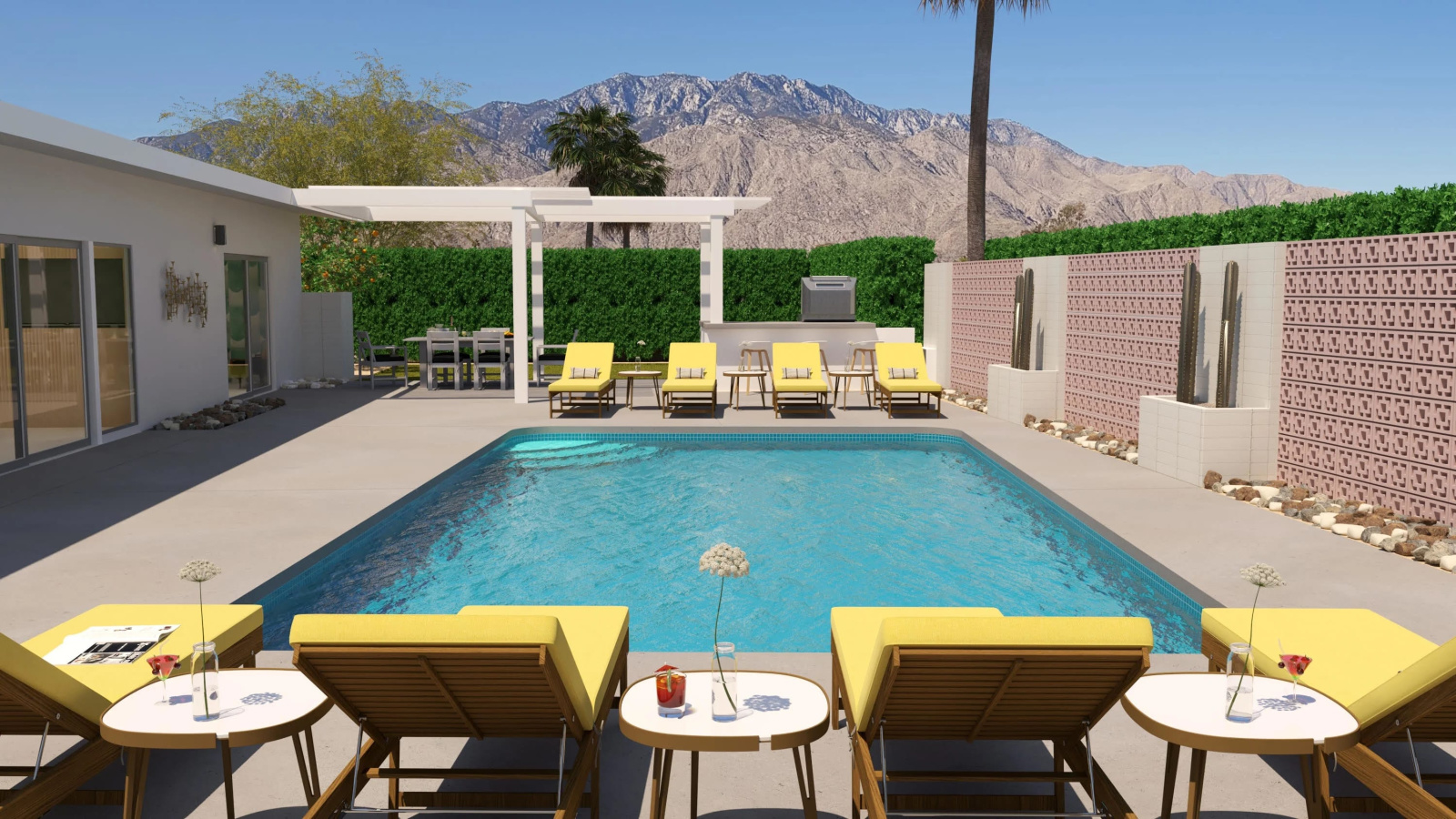 A modernist pool decked up with pale yellow loungers in fabric and pale wood and argilla-tinted tiled walls is set against a mountain background and captured on a sunny day.