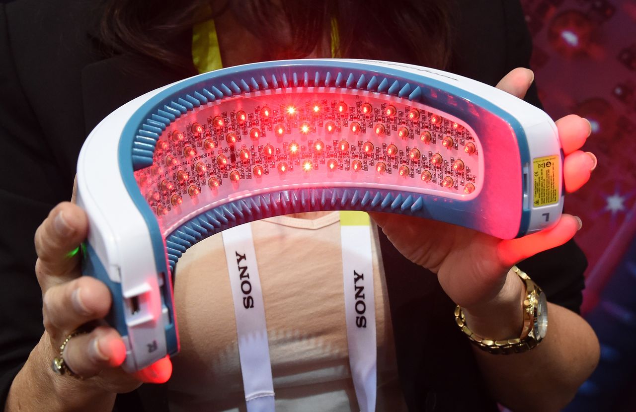 LAS VEGAS, NV - JANUARY 04:Francesca Dubsky display the bottom side of the Hairmax LaserBand 82 during a press event for CES 2016 at the Mandalay Bay Convention Center on January 4, 2016 in L