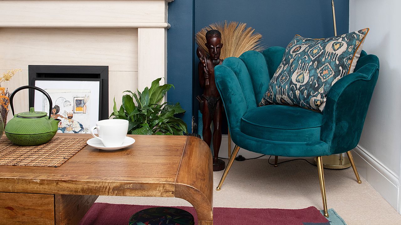 Velvet armchair in living room with wooden table and decorative rug