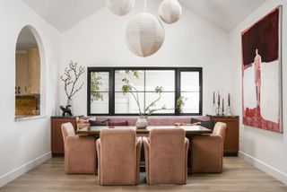 white dining room with rounded pink dining chairs