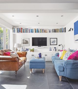 white living room with colourful sofas and cushions