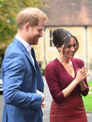 Prince Harry and Meghan Markle animatedly chat at an engagement