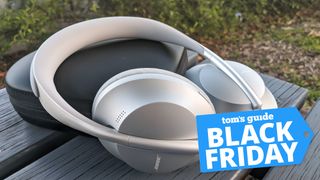 Bose 700 on a picnic bench outside with Black Friday deals tag