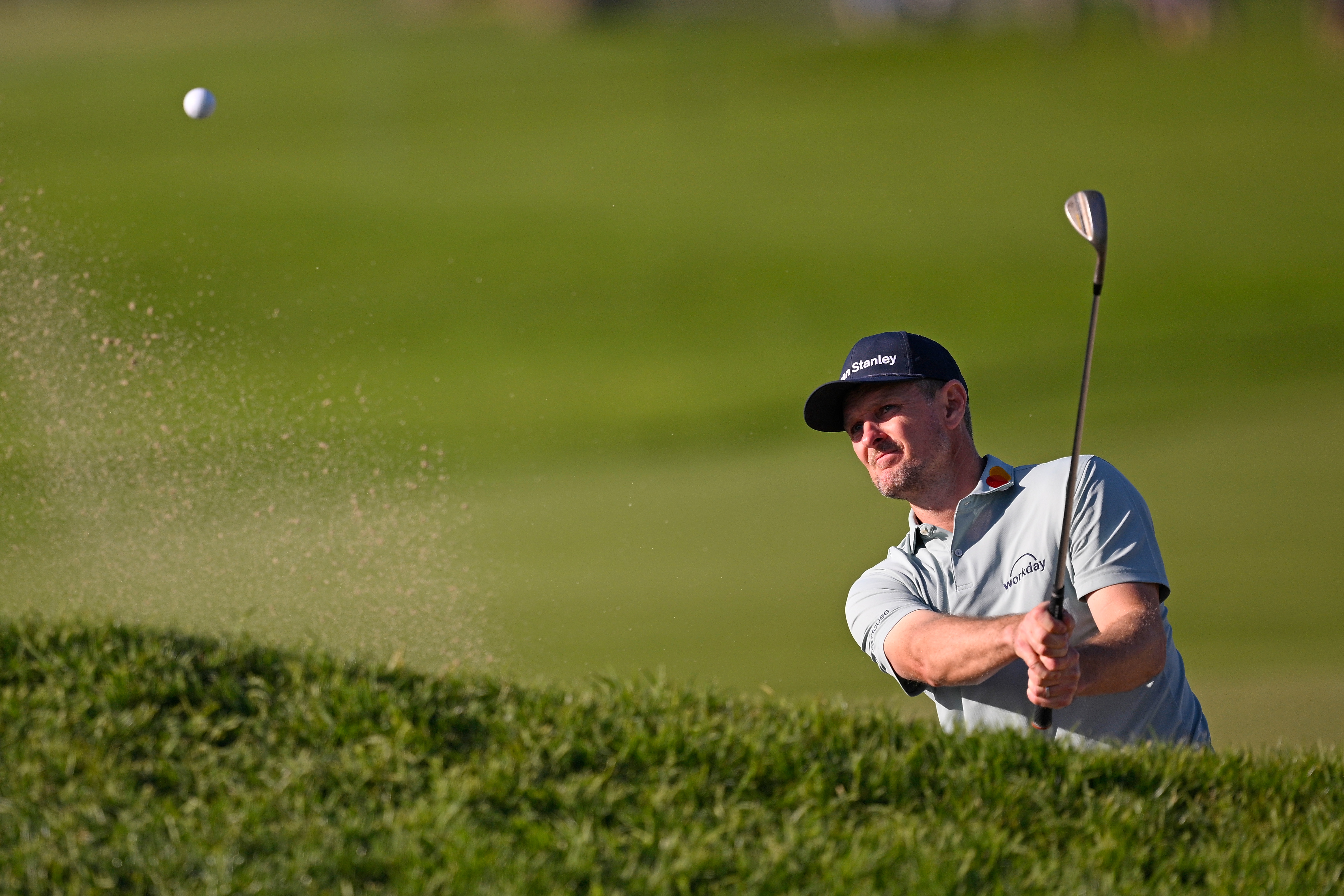 Justin Rose hits a bunker shot