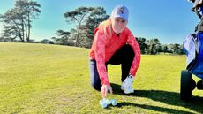 Female golfer selecting a golf ball