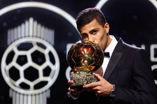 Manchester City's Spanish midfielder Rodri kisses the trophy as he receives the Ballon d'Or award during the 2024 Ballon d'Or France Football award ceremony at the Theatre du Chatelet in Paris on October 28, 2024. 