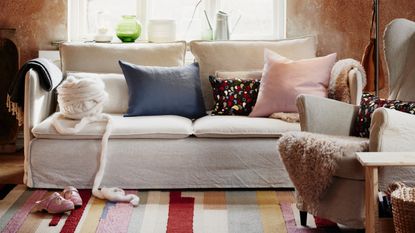 folklore fusion image of a living room, with a beige/grey sofa, brown walls, a large window, and a colourful geometric rug