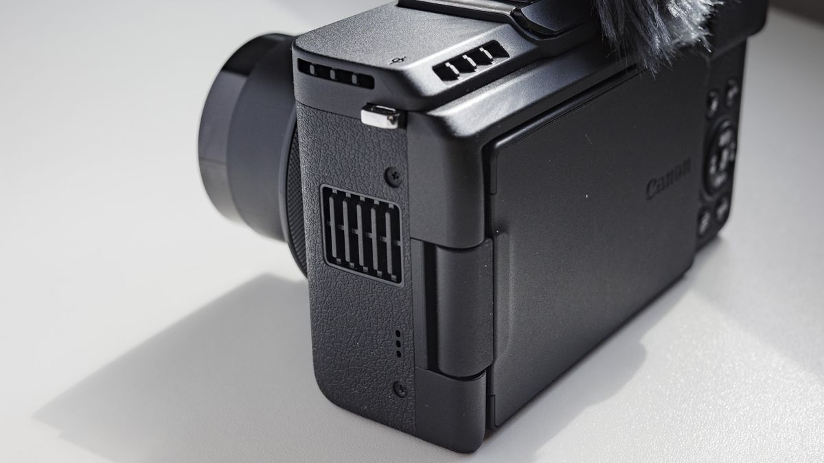 Closeup of Canon PowerShot V1 compact vlogging camera's cooling vents, on a white desk