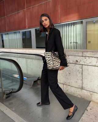 French fashion influencer Salome Mory wearing a chic fall outfit with black pants in Paris.