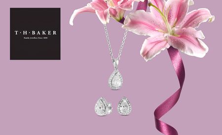 T H Baker logo top left with a picture of necklace hanging off pink lillies