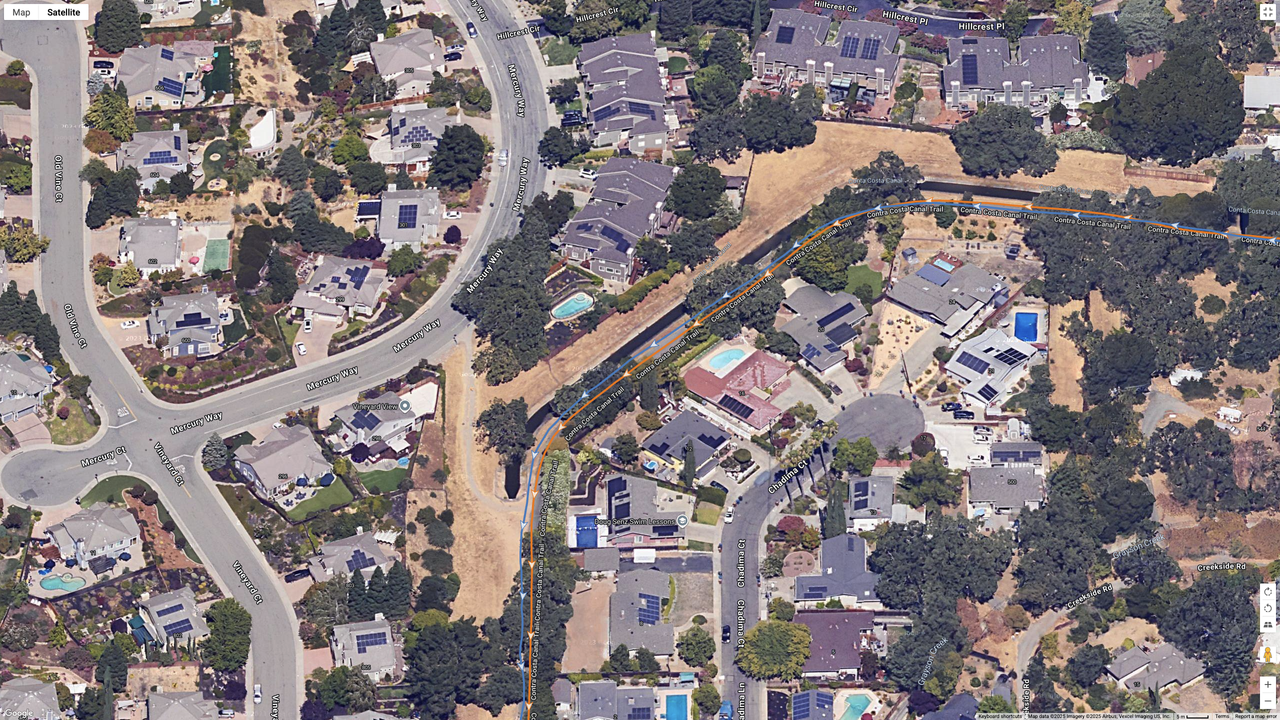 A Google Maps satellite image showing how the COROS PACE 4 (orange line) compares to the Garmin Forerunner 970 (blue line) for dual-frequency GPS accuracy for a suburban route.