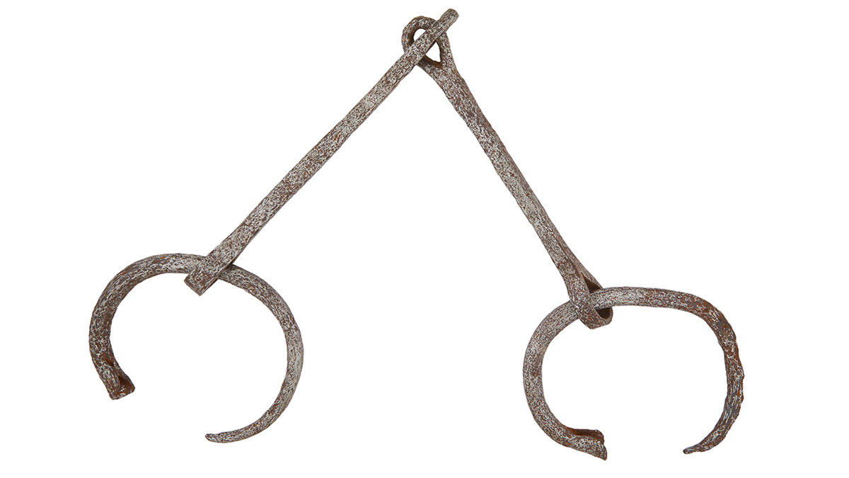 A set of iron ankle shackles in which the rings are slightly open and they are connected by two straight links at a right angle