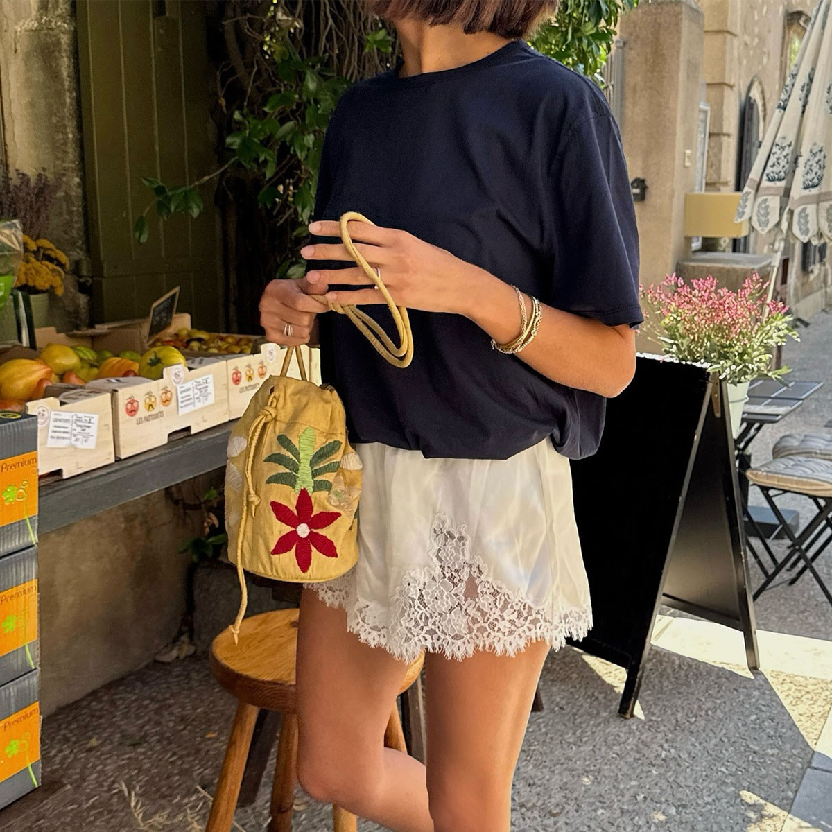 Woman in a black oversize tee and lace-trim shorts