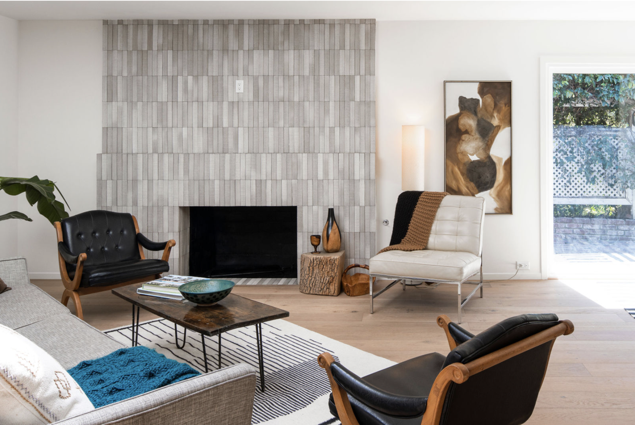 A modern neutral colored living room with tan and cream leather chairs