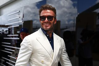 David Beckham wearing sunglasses and smiling