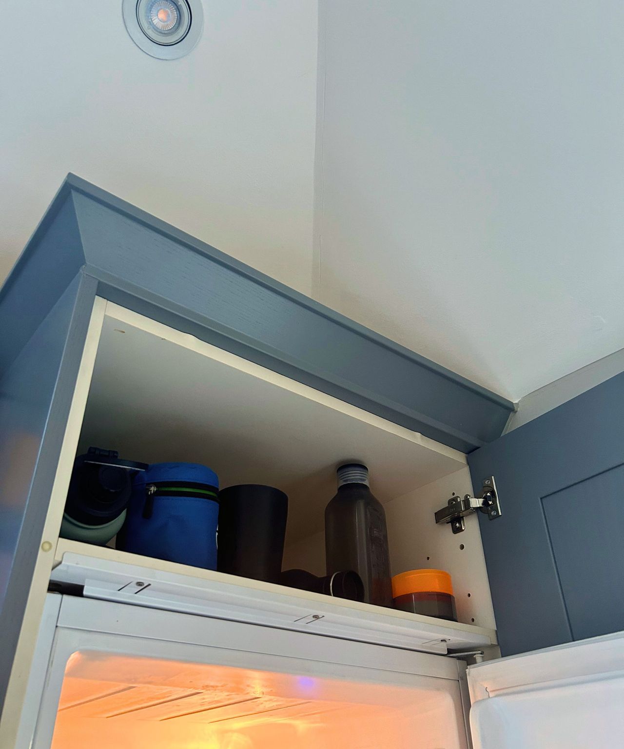Before, reusable bottles filled the top of the cupboard space