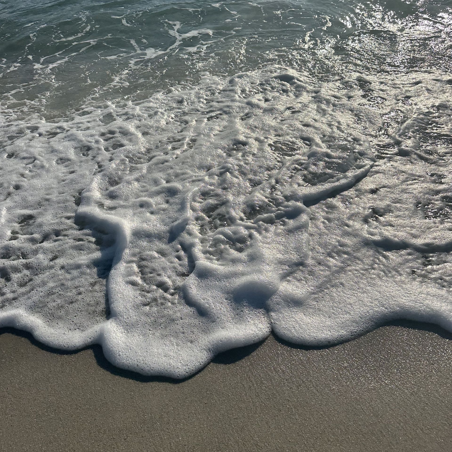 Waves foaming on the shore