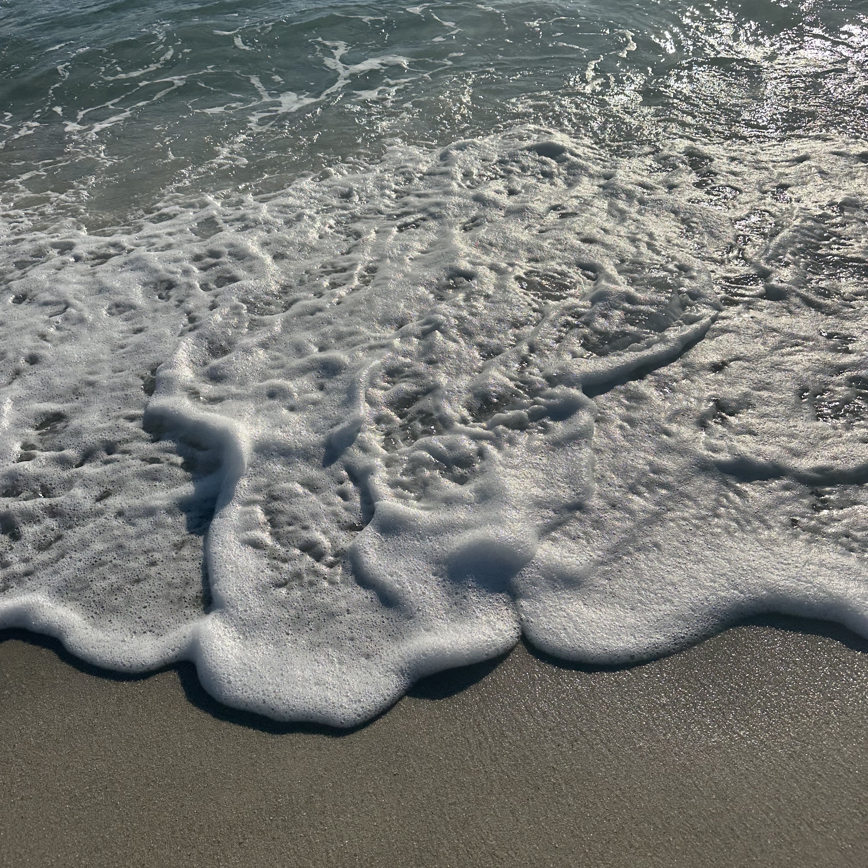 Waves foaming on the shore