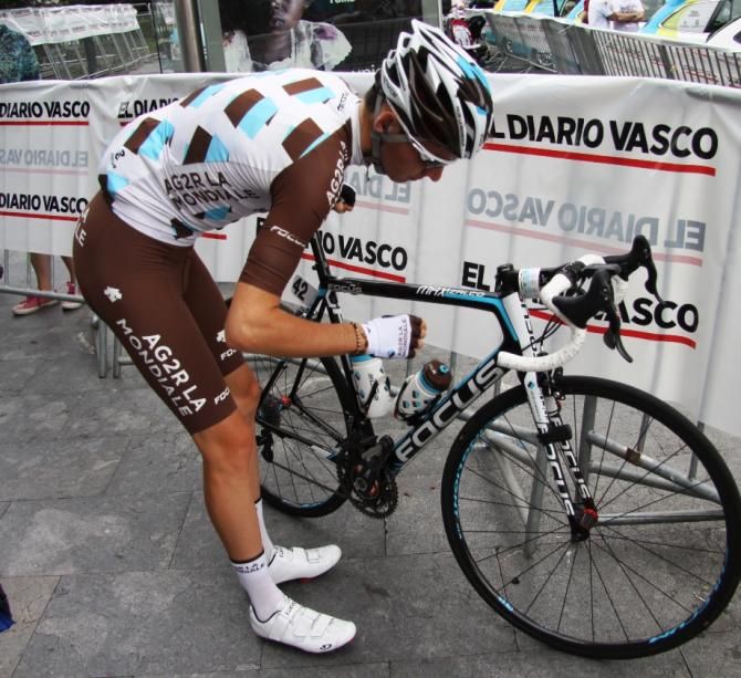 Romain Bardet checks his bike before the race