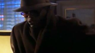 Samuel L. Jackson wearing a big coat, hat and sunglasses.