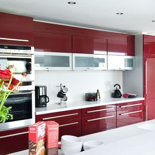 kitchen area with burgandy cabinets and oven