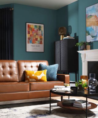 A teal living room with a brown couch and coffee table