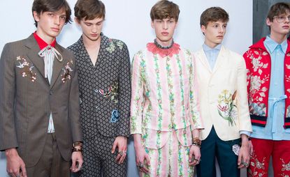 5 male models lined up wearing colourful clothing