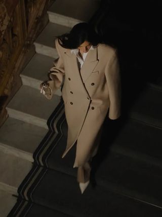 Woman wearing long coat.