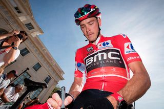Rohan Dennis in red before the start of the stage